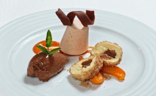 Cheese dumplings on fruit sauce with chocolate ice cream and parfait